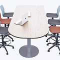 Wooden Conference Table With Laptop Keyboard And Colorful Chairs In Office