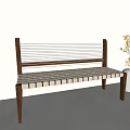 Leisure Bench With Wooden Frame And Woven White Seat Near White Vase With Yellow Flowers