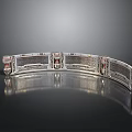 Silver Filigree Bracelet With Red Gemstones And Engraved Patterns On Sleek Surface