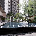 Modern High Rise Residential Landscape With Pool White Swan Sculptures And Green Trees
