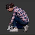 A Woman Wearing Plaid Shirt And White Gloves Squatting On Black Floor Checking Surface