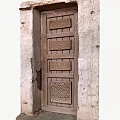 Traditional Building Exterior Wall with Intricate Carved Wooden Door and Rough Texture