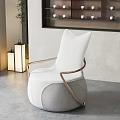 Elegant White Single Sofa With Gold Metal Armrests And Modern Design In Gray Interior With Green Plant
