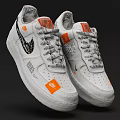 White Low Top Sneakers Featuring Orange Patches Black Designs And Gray Laces