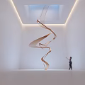 Spiral Wooden Art Installation in Bright White Room With Skylight and Person Standing Beside