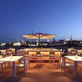 Outdoor Seaside Bar With Illuminated Counter And Umbrella Seating Area