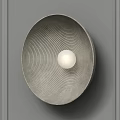 Modern Circular Wall Sconce With Textured Surface And White Globe Bulb On Gray Wall 3d model