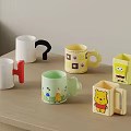 Colorful Cartoon Character Mugs With Winnie The Pooh And SpongeBob Designs On Wooden Table