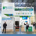 Sanquin Plasma Exhibition Booth With Green Backdrop Reception Desk And Screen