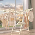 White Clothes Drying Rack Holds Hanging Yellow Heart T-shirts Baby Clothes and Folded Towels