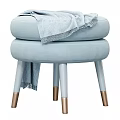Light Blue Stool With Layered Seat Cushions Legs Gold Accents Draped Blanket