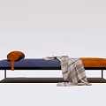 Modern Ottoman With Blue Orange Upholstery Pillow Checkered Blanket And Metal Legs