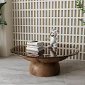 Glass Top Round Coffee Table With Wooden Base Books Astronaut Figurine And Lattice Wall