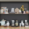 Organized Kitchenware Display On Shelf With Glass Jars Teapot Sugar Container Cups And Decorative Leaves