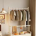 White Metal Clothes Rack with Hanging Casual T-shirts Sweaters in Cozy Home Interior Setup
