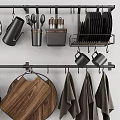 Stylish Kitchen Utensils Display With Hanging Metal Racks Wooden Cutting Board And Black Towels