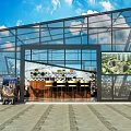 Modern Glass Building With Geometric Roof Metal Frame Indoor Seating Plants And Billboards