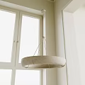 Round Beige Fabric Pendant Light Hanging with Ropes in Bright Room Near Window White Walls