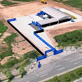 Aerial View Of Construction Site With Building Structure Construction Equipment Road And Green Trees