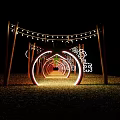 Enlightened Wooden Pergola With Circular Light Rings And String Lights Creating Tunnel Effect On Grass