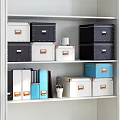 Organized Blue White Folders With Leather Trim Stacked Near Pen Holder Notebook And Mug