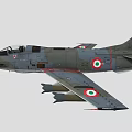 Military Fighter Jet With Camouflage Paint And Weapons Under Wings In Flight
