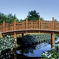 Wooden Landscape Bridge With Intricate Carved Railings Surrounded By Lush Green Trees And Grass