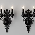 Two Black Classical Wall Sconces With Candle Shaped Lights And Floral Carved Design