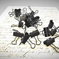 Pile of Black Binder Clips as Practical Daily Supplies on Paper with Text