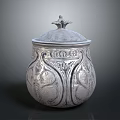 Silver Decorative Storage Jar With Ornate Carved Patterns And Bird Shaped Lid Handle