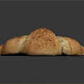Golden Crispy Freshly Baked Croissant With Flaky Interior Shiny Crust On Black Reflective Surface