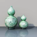 Two Green Gourd Shaped Ceramic Sculptures With Intricate Carved Patterns On Table 3d model