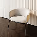 Modern Beige Upholstered Accent Chair With Metal Legs Against Textured Wall And Herringbone Floor