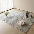 Square Area Rug with Wavy Pattern Neutral Tones on Wooden Floor with Vase and Magazines