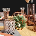 Elegant Dining Table Setup With Leaf Pattern Plates Copper Cutlery And Glass Cups