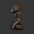 Realistic Brown Baby Gorilla Sculpture In Sitting Posture With Smooth Surface And Gray Background