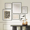 Stylish Wall Decor With Various Framed Artworks And Decorative Glass Bottles