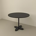 Minimalist Black Round Dining Table With Unique Base In Light Colored Room 3d model