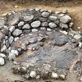Natural Circular Stone Enclosed Depression With Muddy Ground And Water Puddles