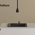 Poliform Black Faucet With Water Droplet Above Black Sink On White Countertop Against Beige Wall