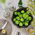 Ceramic Bowl Filled With Fresh Limes On Kitchen Counter With Glasses Coasters And Green Plant