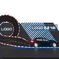 Modern Display Shelf Showcasing Blue Sports Car On Spiral Track With Neon Logo Sign