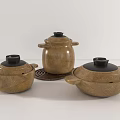 Set of Three Brown Casserole Pots With Black Lids And Handles For Home Kitchen