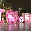 Outdoor Night Display With Large Pink Letters And Heart Shaped Structure