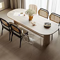 Modern Oval Wooden Dining Table Set with Rattan Back Black Leg Chairs and Vase Flowers