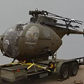 United States Army Olive Green Military Helicopter Displayed On Transport Trailer Outdoor