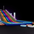 Rainbow Colored Inflatable Slide Play Equipment With Surrounding Tires And Flags