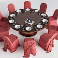 Elegant Round Dining Table With Red Chair Covers White Plates And Decorative Centerpiece