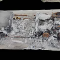 Burned Debris Of Damaged Item On Road Surface With Charred And Broken Parts