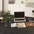Modern Laptop On Desk With Plant Speaker Open Book Notebook And Wall